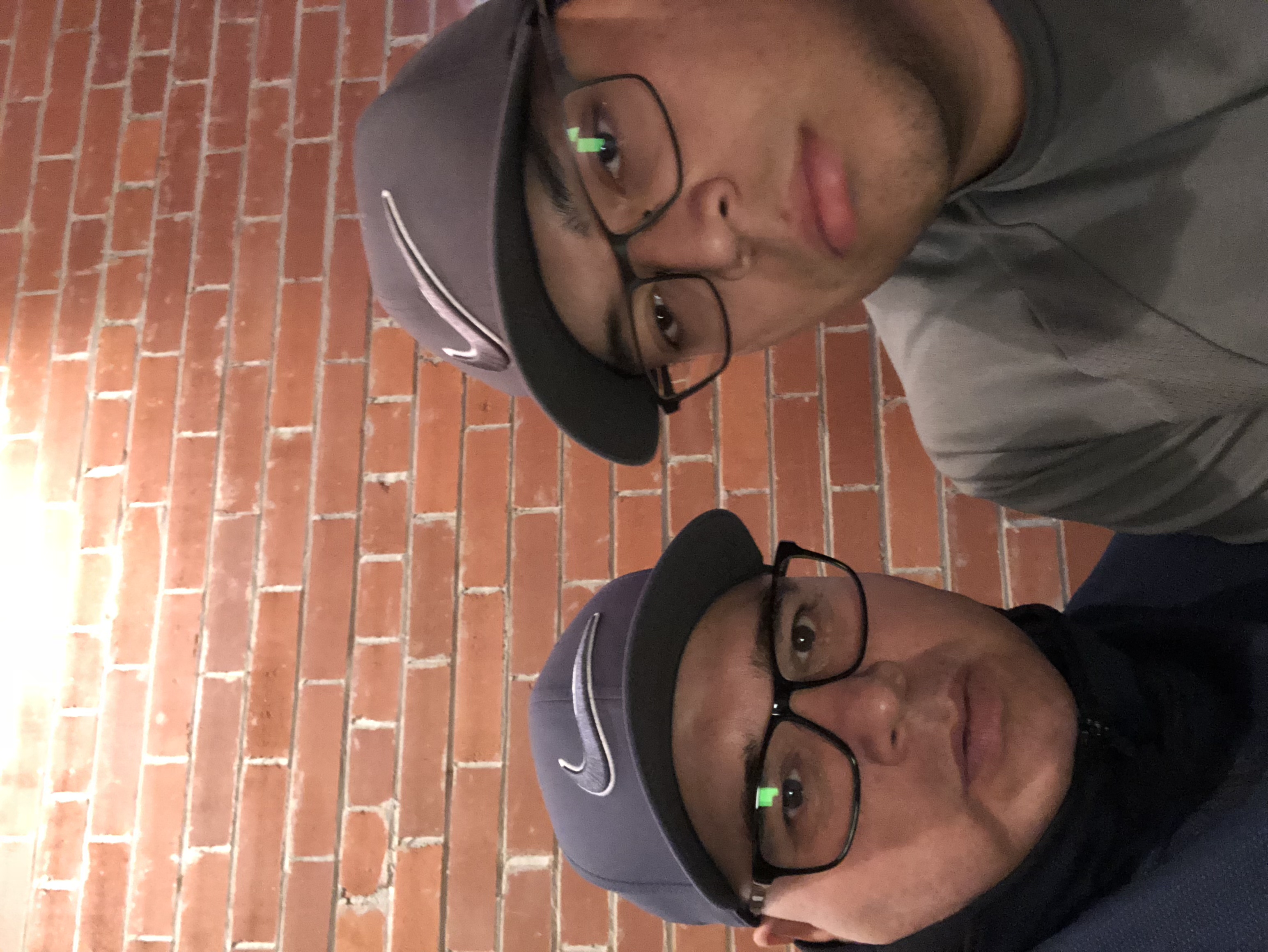 Delbert Wapass with a family member in matching caps